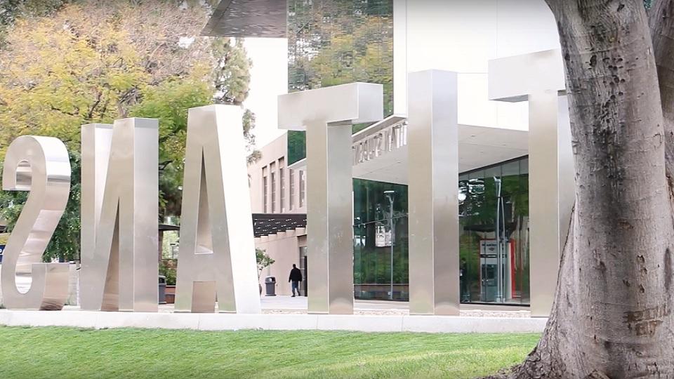 Large metal letters spell Titans on campus